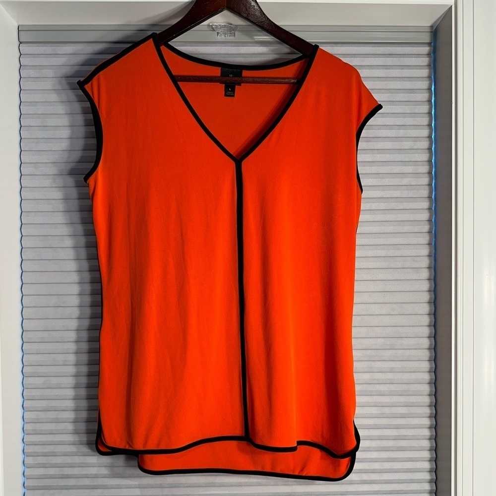 Orange blouse with black trim